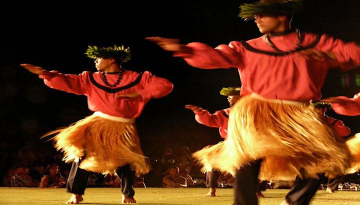 Luau Buffet & Show A group of people in hula skirts performing.