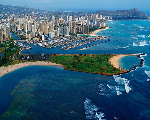 Aerial view of Honolulu, Hawaii, showcasing the vibrant cityscape, lush mountains, and stunning coastline.
