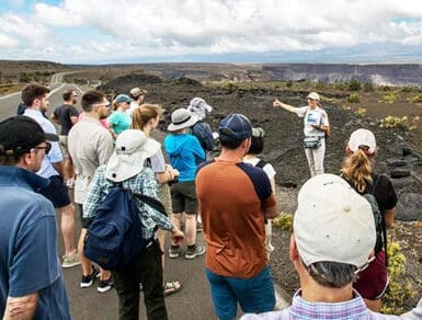 Volcanoes Park Big Island A group of people standing around on the side of a road.