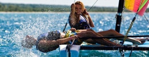 Hawaii Travel Agent A man and woman on water skis in the ocean.